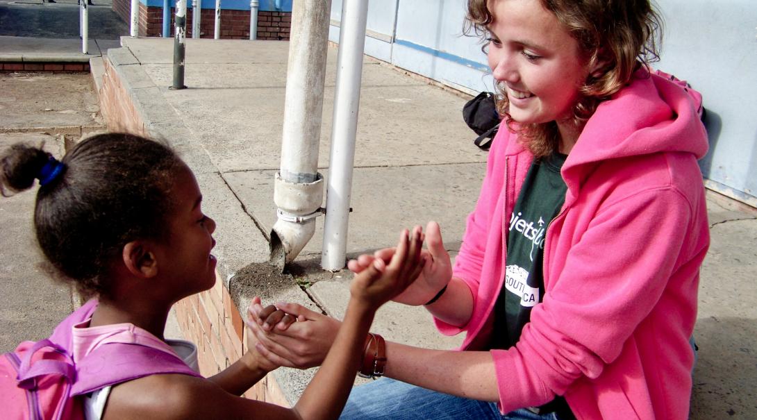 Projects Abroad volunteer works with a South Africa child during her gap year in 2019 Global Gap Year programme volunteer plays a game with a child during her project in South Africa